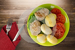 Cutlet with potatoes on lime plate top view