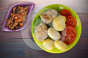 Cutlet with potatoes on lime plate top view