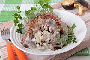 Cutlets of buckwheat with mushroom sauce on plate