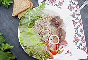 Cutlets with buckwheat porridge and salad. Healthy eating concept. Macro photo. Top view and side view. Erupny plan of the dish