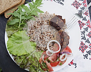 Cutlets with buckwheat porridge and salad. Healthy eating concept. Macro photo. Top view and side view. Erupny plan of the dish