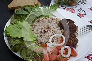 Cutlets with buckwheat porridge and salad. Healthy eating concept. Macro photo. Top view and side view. Erupny plan of the dish