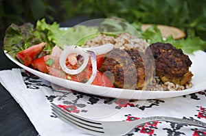 Cutlets with buckwheat porridge and salad. Healthy eating concept. Macro photo. Top view and side view. Erupny plan of the dish