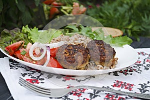 Cutlets with buckwheat porridge and salad. Healthy eating concept. Macro photo. Top view and side view. Erupny plan of the dish