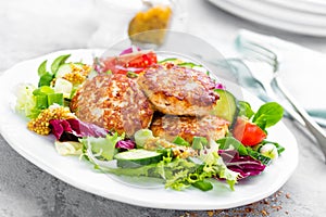 Cutlets and fresh vegetable salad on white plate. Fried meatballs with vegetable salad