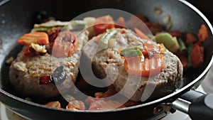 Cutlets for hamburgers are fried in a frying pan in the home kitchen