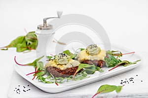 Cutlets on a white plate. Cheese, sauce, greens. White background. Decor.