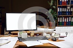 Cutout screen of computer monitor on desk at night, engineering with drawings