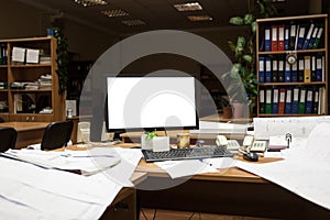 Cutout screen of computer monitor on desk at night time, engineering with drawings