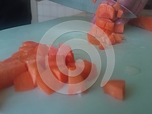 cuts carrots into on a cutting board