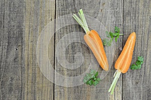 Cuts fresh carrot on wooden table rustic