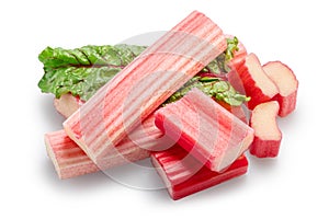 Cuts of red rhubarb on green rhubarb leaf on white background. File contains clipping path