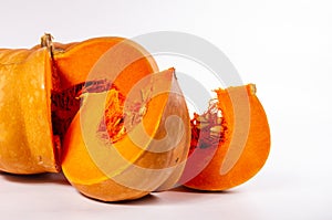Cutted fresh orange big pumpkin on white background, close up. Organic agricultural product, ingredients for cooking