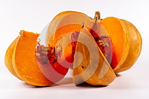 Cutted fresh orange big pumpkin on white background, close up. Organic agricultural product, ingredients for cooking