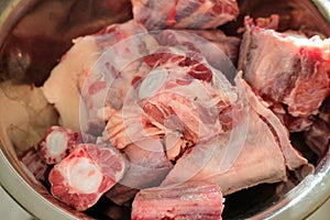 Cutted oxtail in a bowl. Raw meat