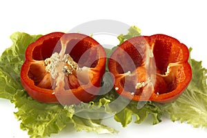 Cutted sweet red pepper on salad leaves