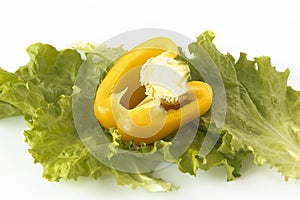 Cutted sweet yellow pepper on salad leaves