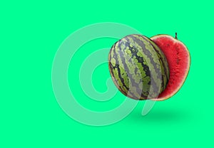 Cutted watermelon isolated on green pastel background with a shadow and copy space