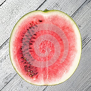 Cutted watermelon on white wooden surface