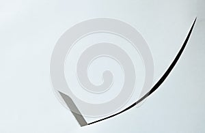 Cutter blade curve slashing on white paper background photo