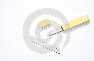 Cutter blade in yellow box package on white background