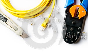 Cutter, crimper, yellow patch cord and connectors photo