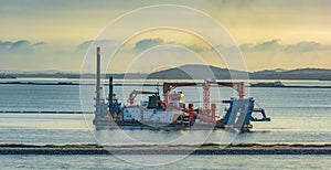 Cutter suction dredger at work of land reclamation. Singapore, Southeast Asia