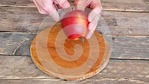 Cutting The Apple In Two Pieces on Wooden Background
