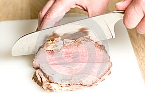 Cutting baked ham photo