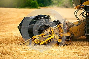 Cutting bar unit or reaper machine cuts stems. Combine harvester working in wheat field. Harvesting machine driver