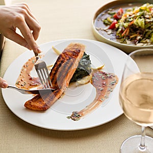 Cutting beautiful salmon meal with lemon photo