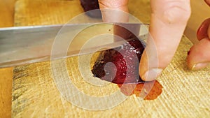 Cutting beet with sharp chef knife macro shot, cooking process, preparing ingredients for Tar Tar, slow motion