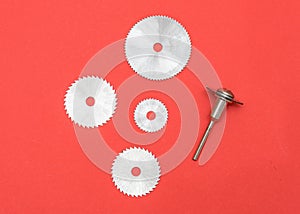 Cutting blades for professional engraving machine isolated on red color. Dremel attachments photo