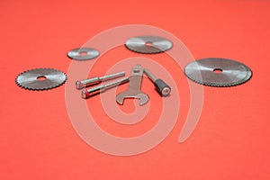 Cutting blades for professional engraving machine isolated on red color. Dremel attachments photo