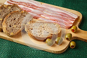 Cutting board with bacon and bread