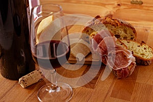 Cutting board cheese bread and red wine