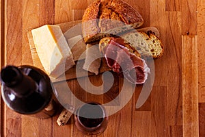 Cutting board cheese bread and red wine