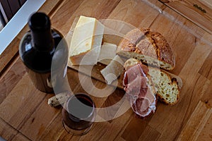 Cutting board cheese bread and red wine