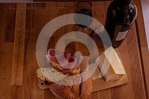 Cutting board cheese bread and red wine