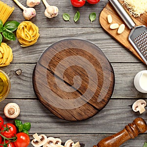 Cutting board with copy space with ingredients for cooking pasta