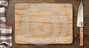 Cutting board and knife on old wood table with