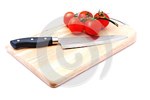 Cutting board with a knife and tomato