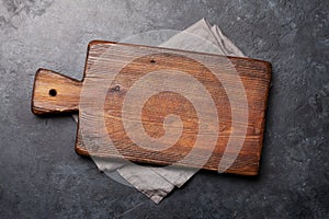 Cutting board over towel on stone kitchen table