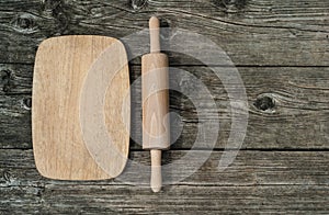 Cutting board with rollingpin on wooden background