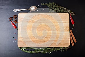 Cutting board with rosemary, thyme, colored and chili pepper, ol