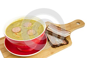 Cutting board with soup bowl filled with so called erwtensoep