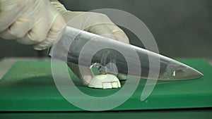 Cutting boiled egg. Male hands cut boiled egg a large knife on a cutting board. Close-up