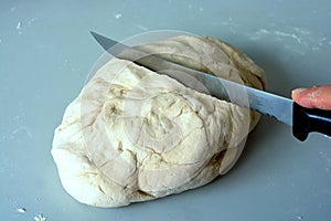 Cutting the bread dough with a knife