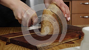 Cutting bread on wooden board