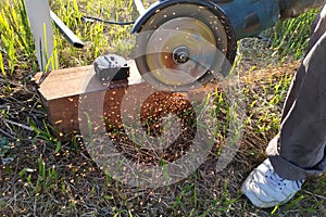 Cutting bricks with an angle grinder, construction work, the process of execution close-up